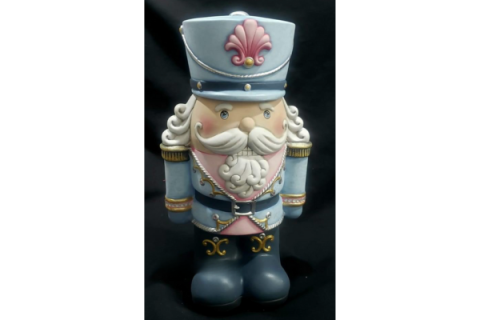 Ceramic Nutcracker with white beard and light blue hat and jacket.